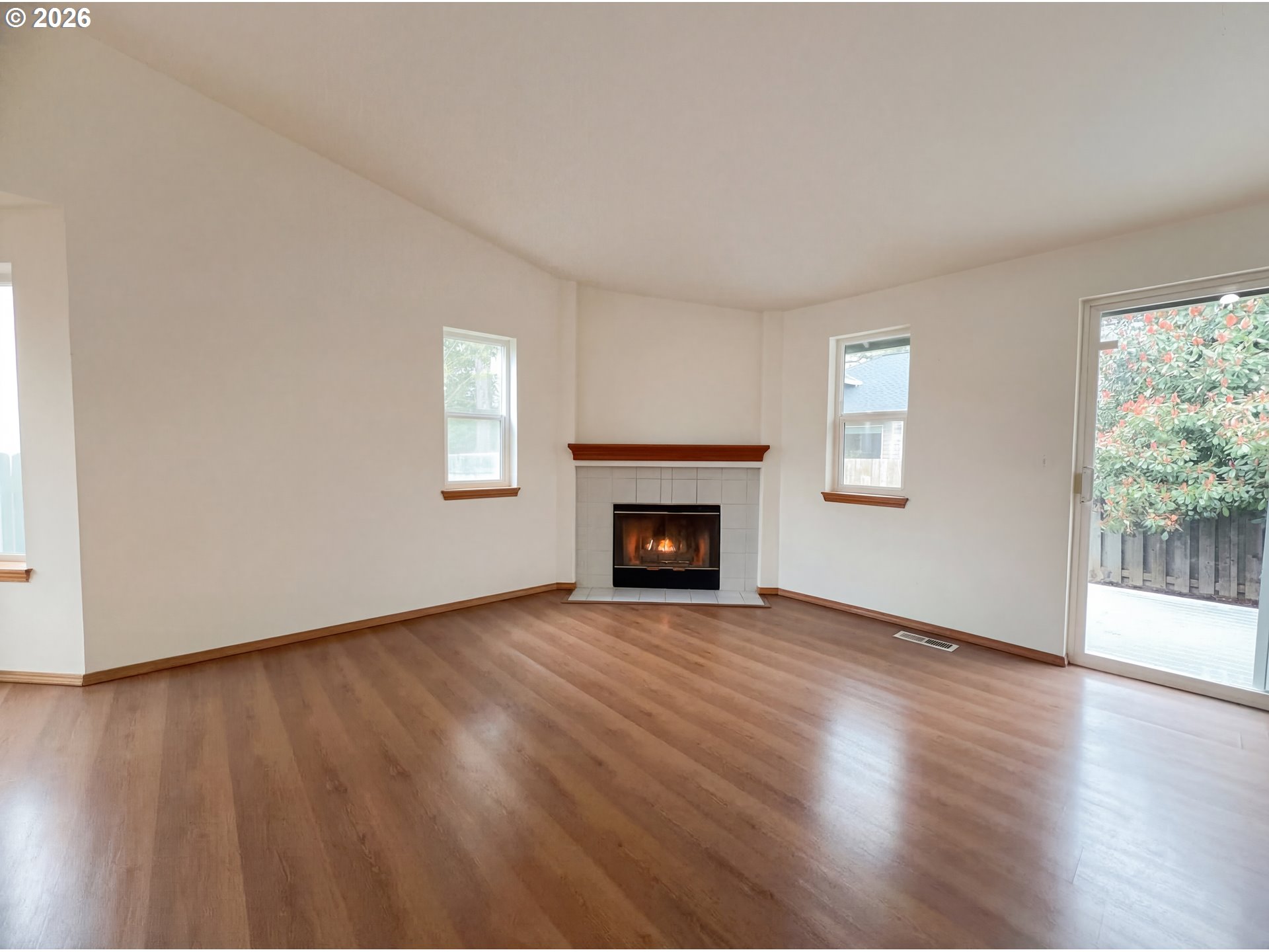 8641 Northeast Windstone Street Beaverton, OR 97006 - Photo 3 of 18 a view of an empty room with wooden floor and a window