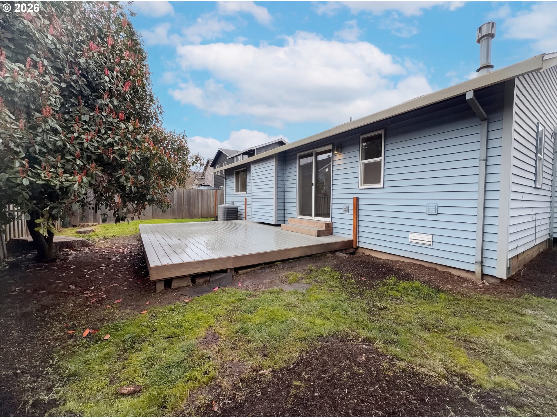8641 Northeast Windstone Street Beaverton, OR 97006 - Photo 5 of 18 a backyard of a house with wooden floor barbeque oven and trees