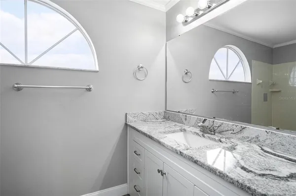 a bathroom with a granite countertop sink a vanity and a mirror