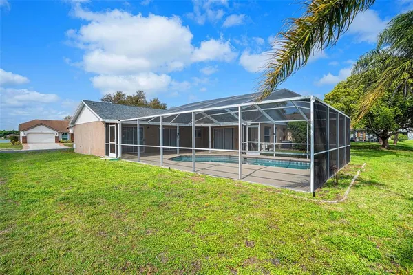 a view of a house with a backyard