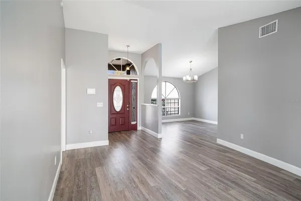 a view of a room with wooden floor and white walls