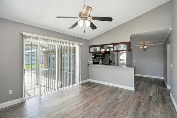 a view of a room with wooden floor