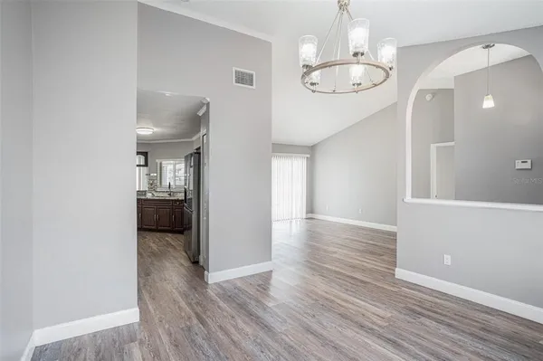 a view of a room with wooden floor and staircase