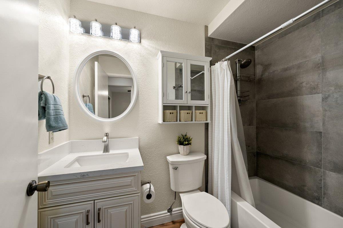 6561 Trinity Way Placerville, CA 95667 - Photo 24 of 58 a bathroom with a sink a mirror a toilet and shower