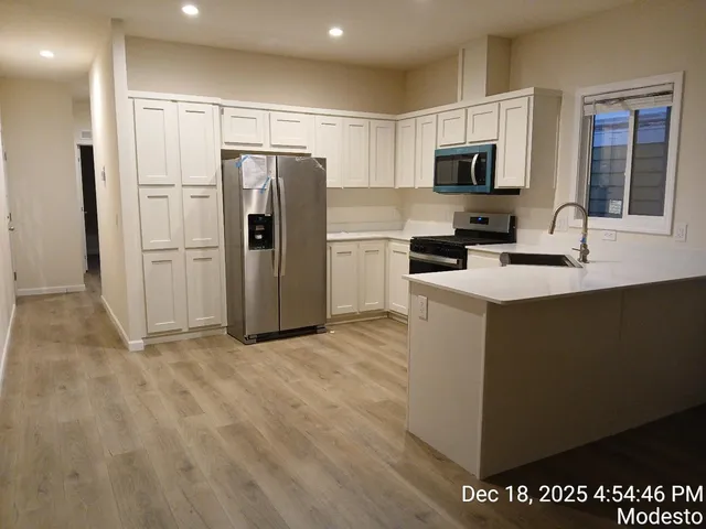 a kitchen with a refrigerator sink and microwave