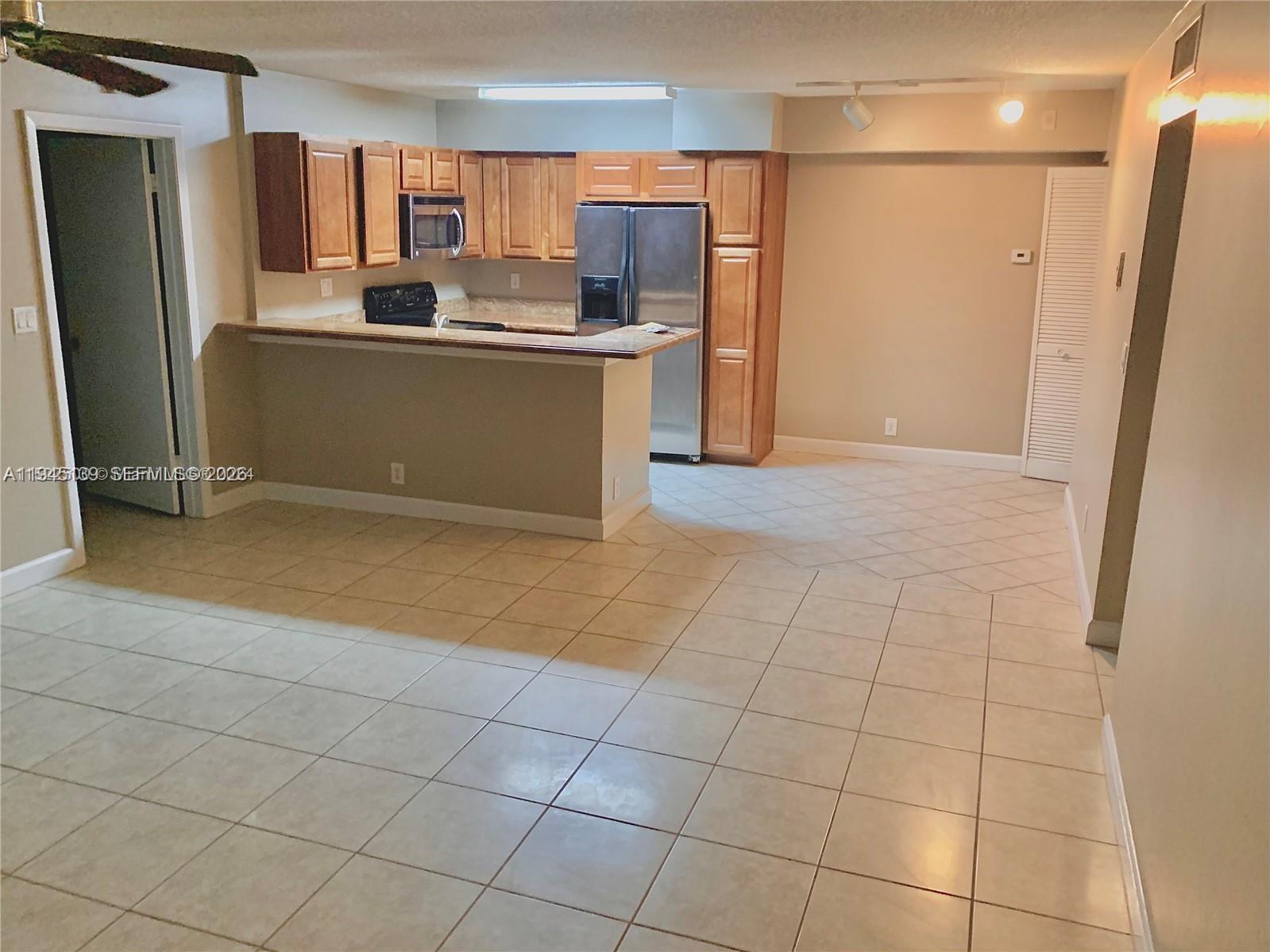 621 Lyons Road, Unit 9101 Coconut Creek, FL 33063 - Photo 5 of 30 LIVING AREA-KITCHEN