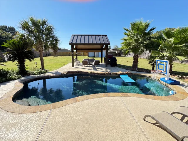 a view of a swimming pool with a patio