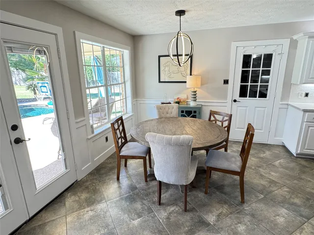 a view of a dining room with furniture window and outside view