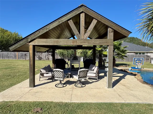 a view of a house with backyard porch and sitting area