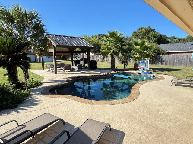 a view of a swimming pool with a patio