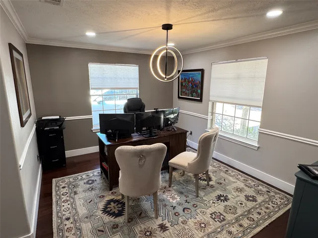 a dining room with furniture a rug and wooden floor