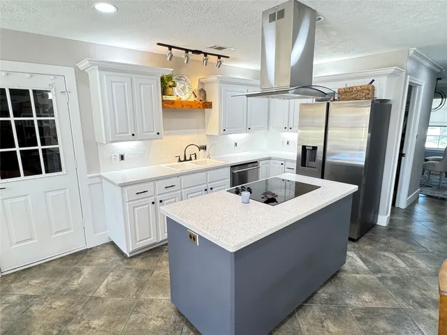 a kitchen with a sink a stove a refrigerator and a window