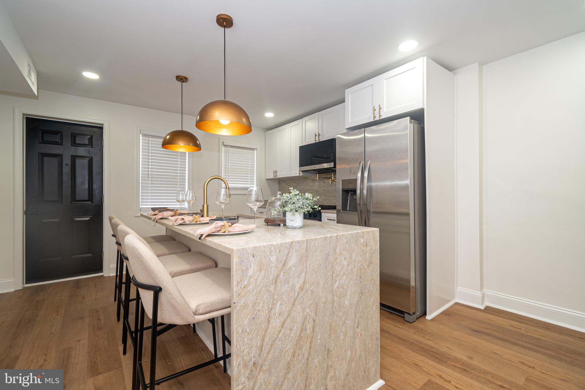 2560 Cecil Avenue Baltimore, MD 21218 - Photo 1 of 11 a kitchen with stainless steel appliances granite countertop a sink a stove and refrigerator