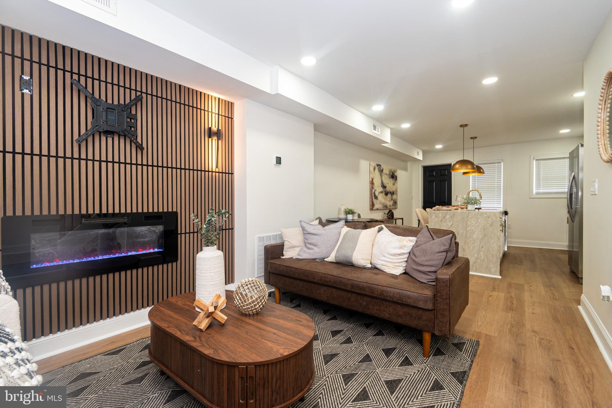 2560 Cecil Avenue Baltimore, MD 21218 - Photo 2 of 11 a living room with furniture and a wooden floor