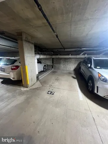 a view of parking garage with cars parked