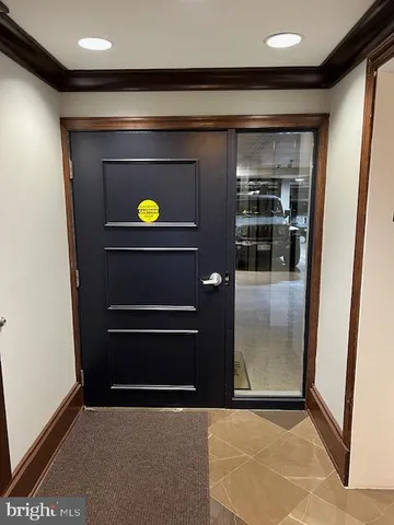 a view of a hallway with wooden floor and furniture
