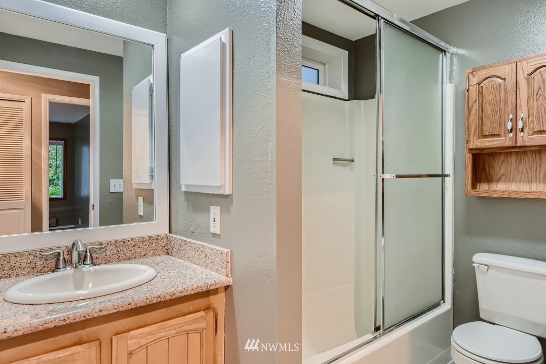 7577 Old Redmond Road, Unit 7 Redmond, WA 98052 - Photo 17 of 21 a bathroom with a granite countertop sink toilet and shower