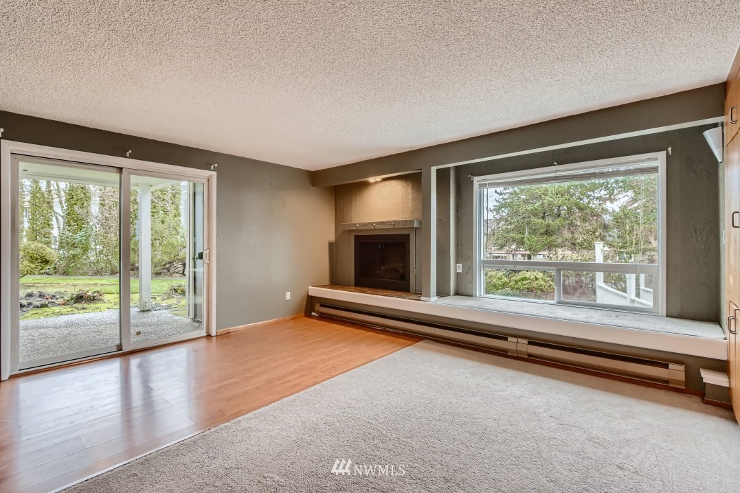 7577 Old Redmond Road, Unit 7 Redmond, WA 98052 - Photo 3 of 21 a view of empty room with wooden floor and fireplace