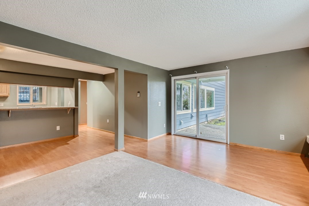 7577 Old Redmond Road, Unit 7 Redmond, WA 98052 - Photo 5 of 21 an empty room with wooden floor and windows