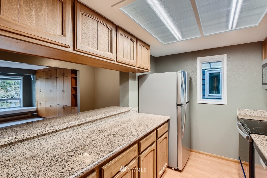 7577 Old Redmond Road, Unit 7 Redmond, WA 98052 - Photo 6 of 21 a view of kitchen with cabinets and refrigerator