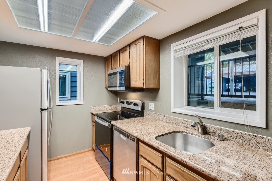 7577 Old Redmond Road, Unit 7 Redmond, WA 98052 - Photo 7 of 21 a kitchen with granite countertop a sink and a window