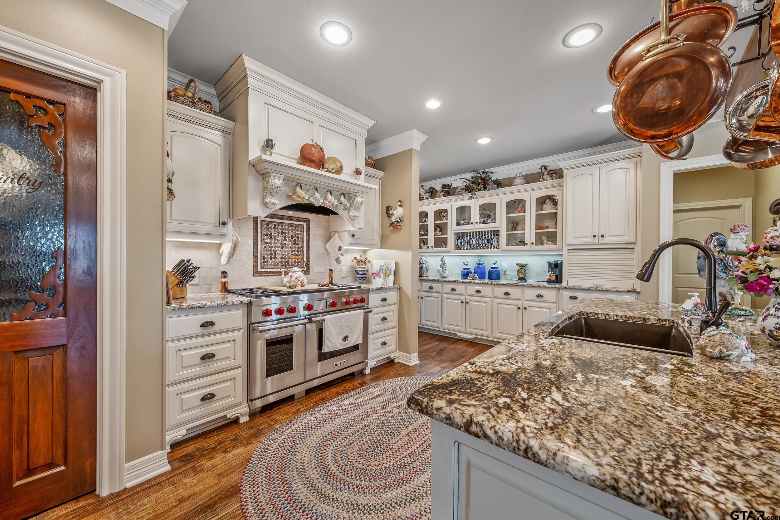 535 Riata Road Bullard, TX 75757 - Photo 11 of 47 a kitchen with stainless steel appliances granite countertop a stove and a sink
