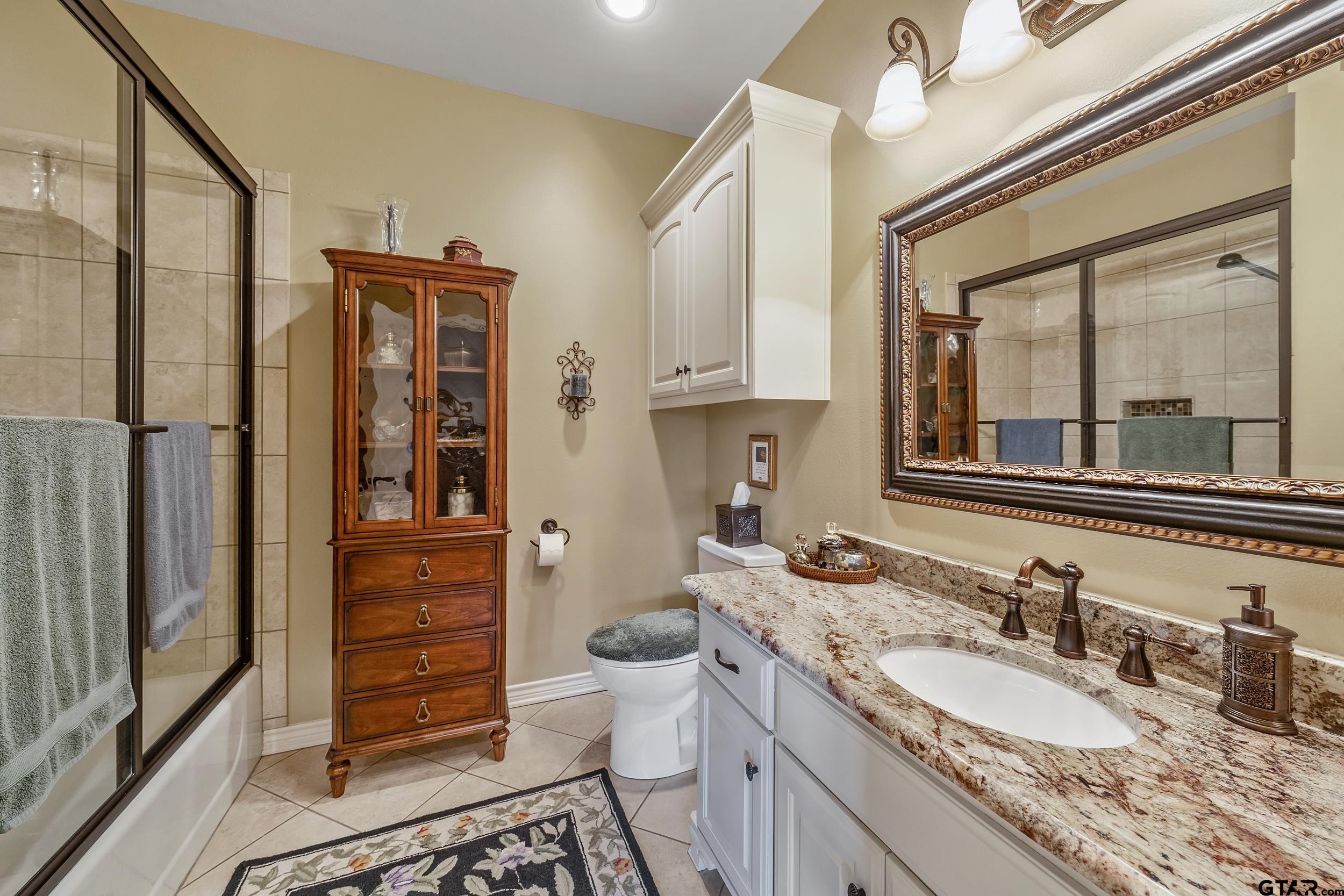 535 Riata Road Bullard, TX 75757 - Photo 21 of 47 a bathroom with a granite countertop sink toilet and shower