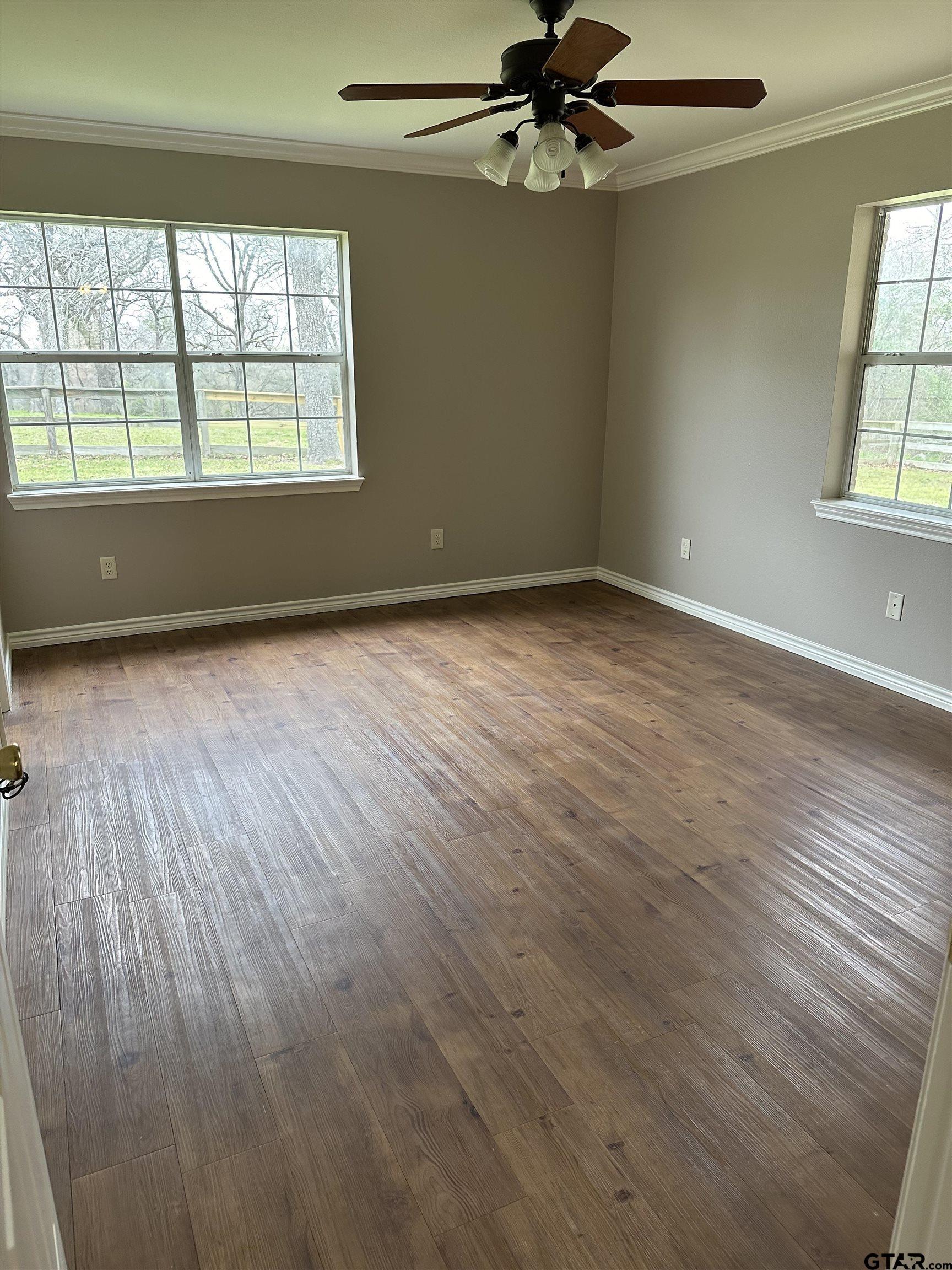 535 Riata Road Bullard, TX 75757 - Photo 45 of 47 an empty room with wooden floor fan and windows