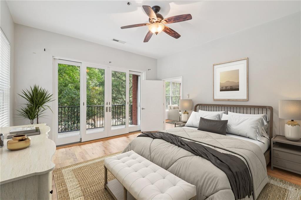 384 Ralph McGill Boulevard Northeast, Unit 105 Atlanta, GA 30312 - Photo 2 of 29 a bedroom with a large bed and a couch