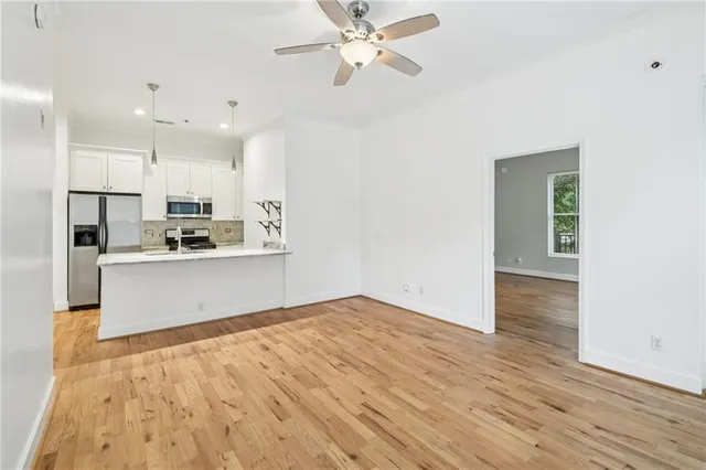a view of kitchen with granite countertop cabinets and wooden floor