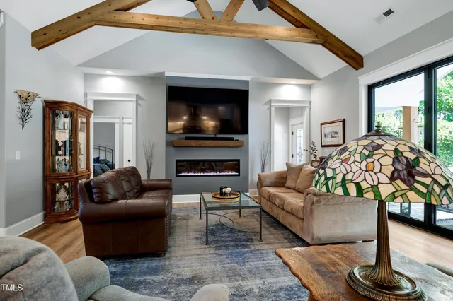 a large white kitchen with a large window a sink and stainless steel appliances