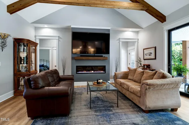 a kitchen with stainless steel appliances kitchen island granite countertop a table chairs stove and white cabinets