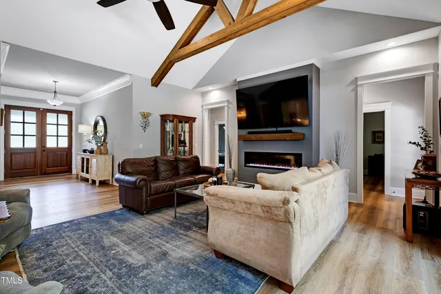 a kitchen with stainless steel appliances granite countertop a table chairs sink refrigerator and microwave