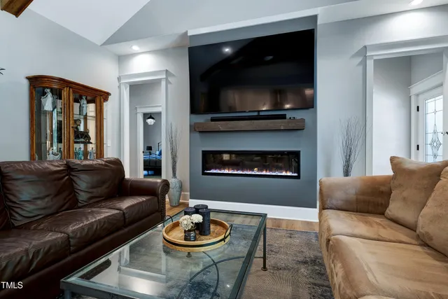 a kitchen with kitchen island granite countertop a stove cabinets and wooden floor