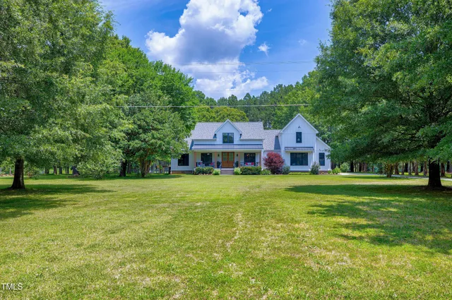 a view of a balcony with chairs and wooden floor