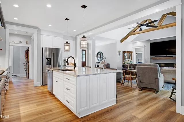 a dining room with furniture window entryway and wooden floor