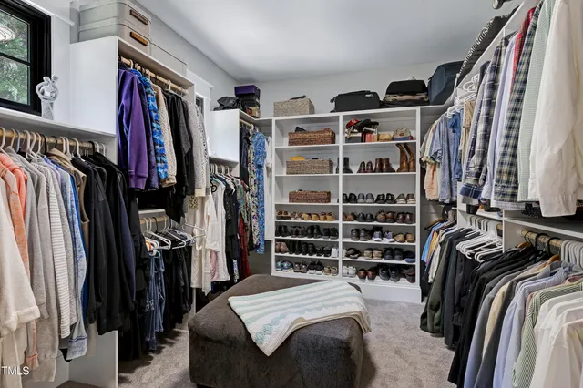 a living room with furniture cabinets and a window