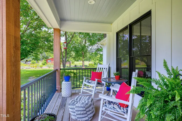 a view of a livingroom with furniture hardwood floor and a ceiling fan