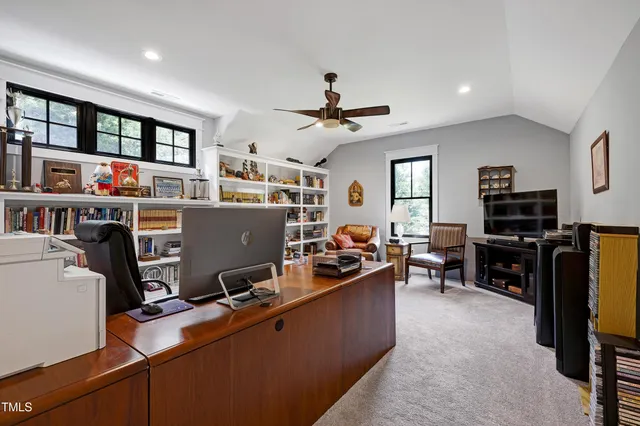 a living room with patio furniture and a potted plant