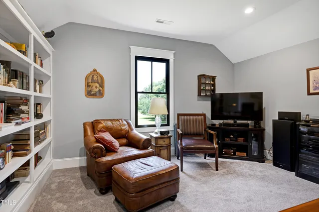 a view of green field with trees in the background