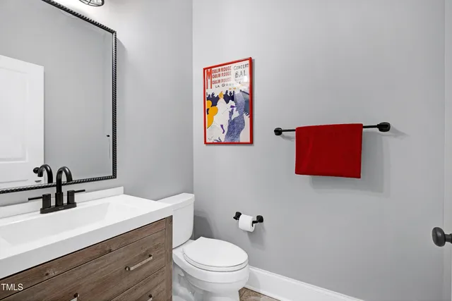 a view of a back yard with flower plants and large trees