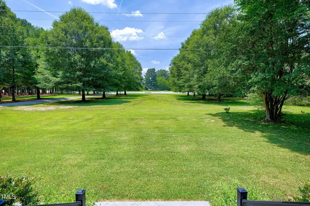 a dining room with furniture a chandelier and wooden floor