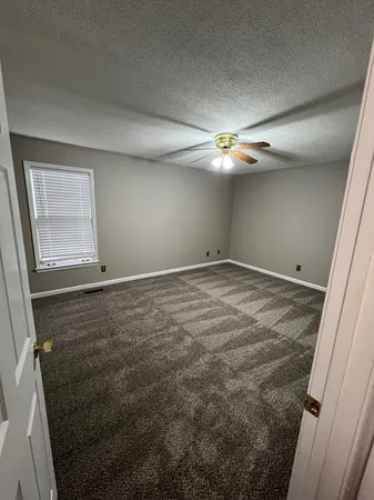 a bathroom with a sink a toilet a window and vanity