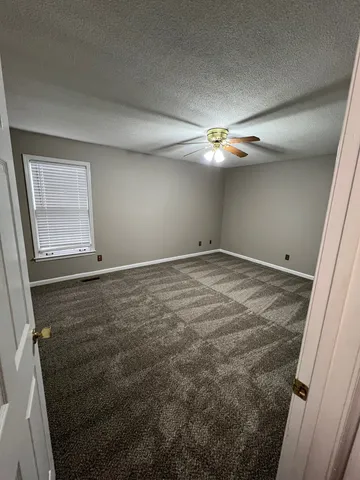 a bathroom with a sink a toilet a window and vanity