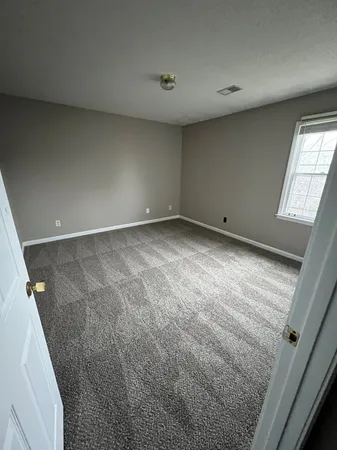 an empty room with a ceiling fan and hardwood floor