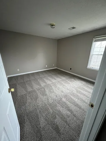an empty room with a ceiling fan and hardwood floor