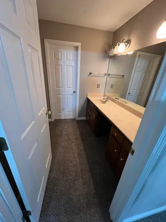 an empty room with a ceiling fan and window