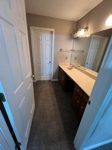 an empty room with a ceiling fan and window