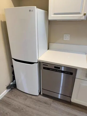 a white refrigerator freezer sitting inside of a kitchen