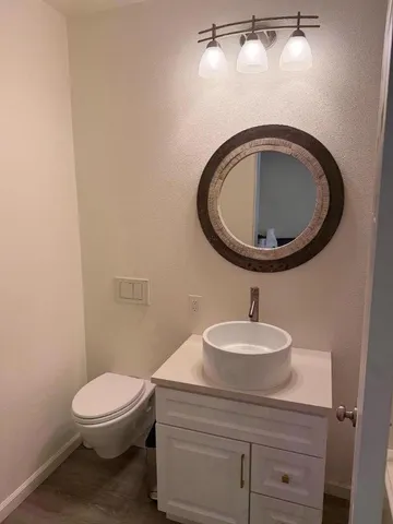 a bathroom with a toilet a sink and a mirror
